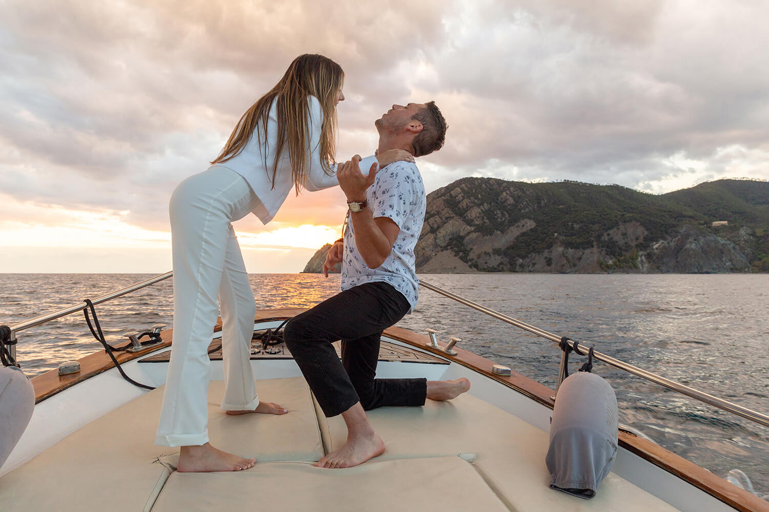 Couple dancing on a boat at sunset in Cinque Terre, Manarola