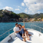 Couple on a boat in front of Monterosso al Mare, Cinque Terre, Italy
