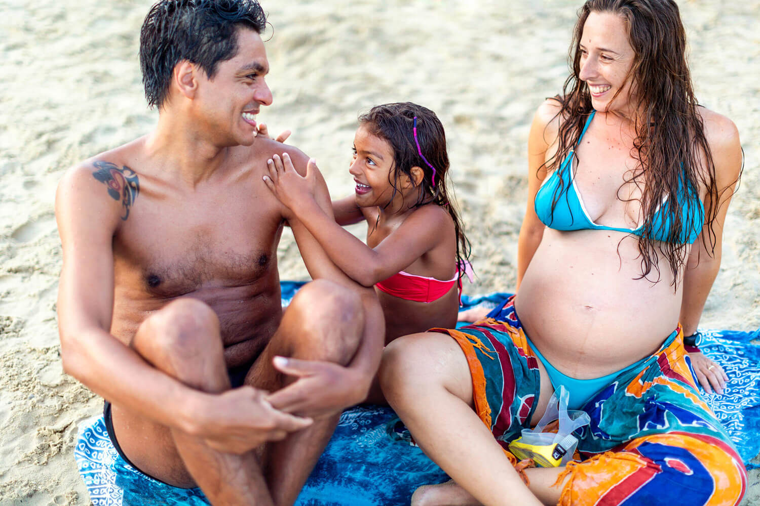 Famiglia in spiaggia con donna in gravidanza, fotografata a La Spezia