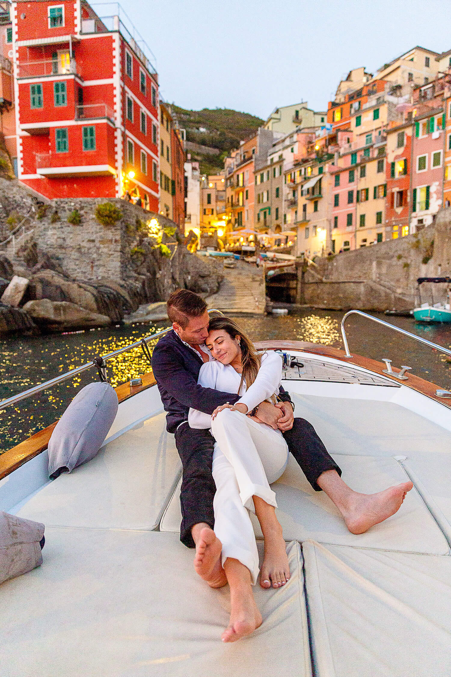 Couple at sunset in Riomaggiore after a surprise proposal in Cinque Terre
