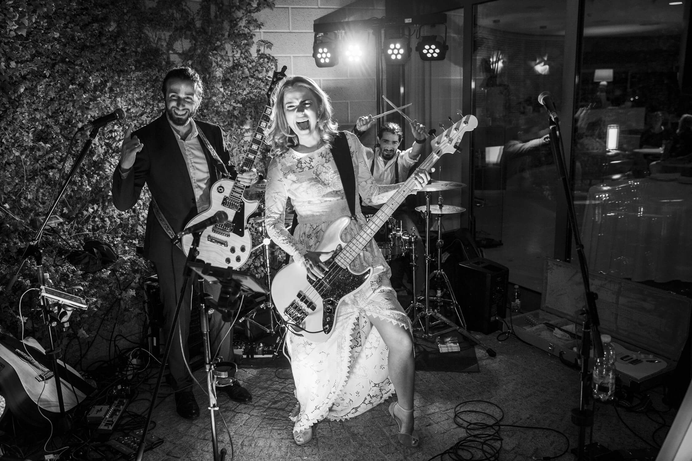 Bride playing guitar at her wedding in Italy