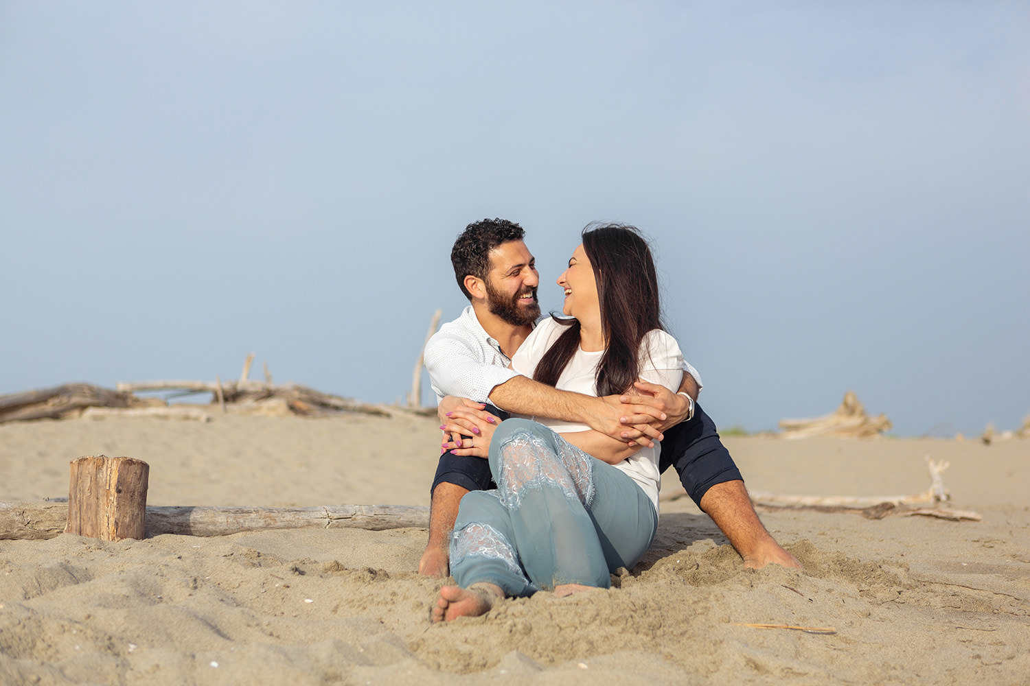 Couple hugging and smiling at the beach