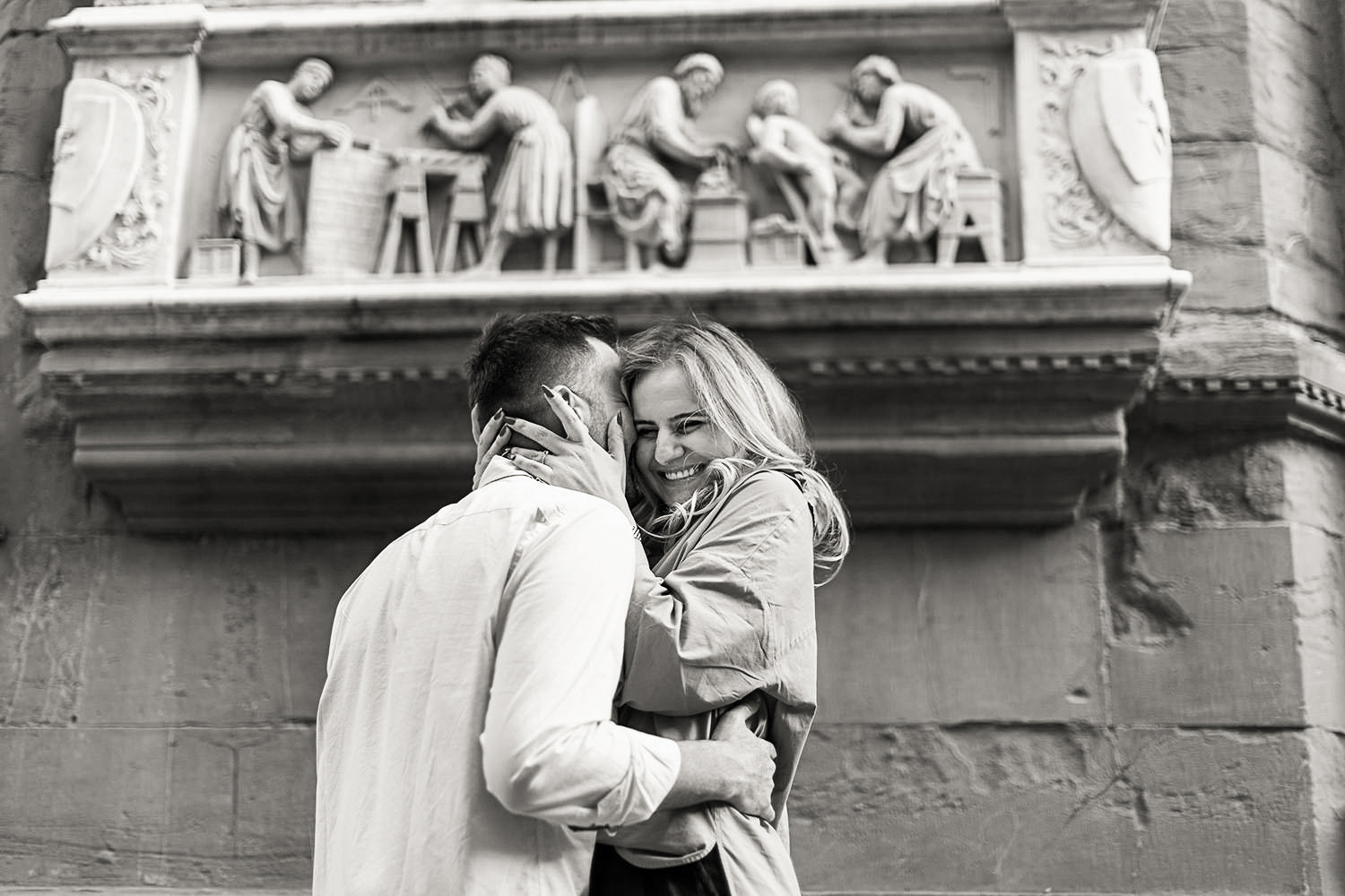 Couple hugging after he proposed in Italy