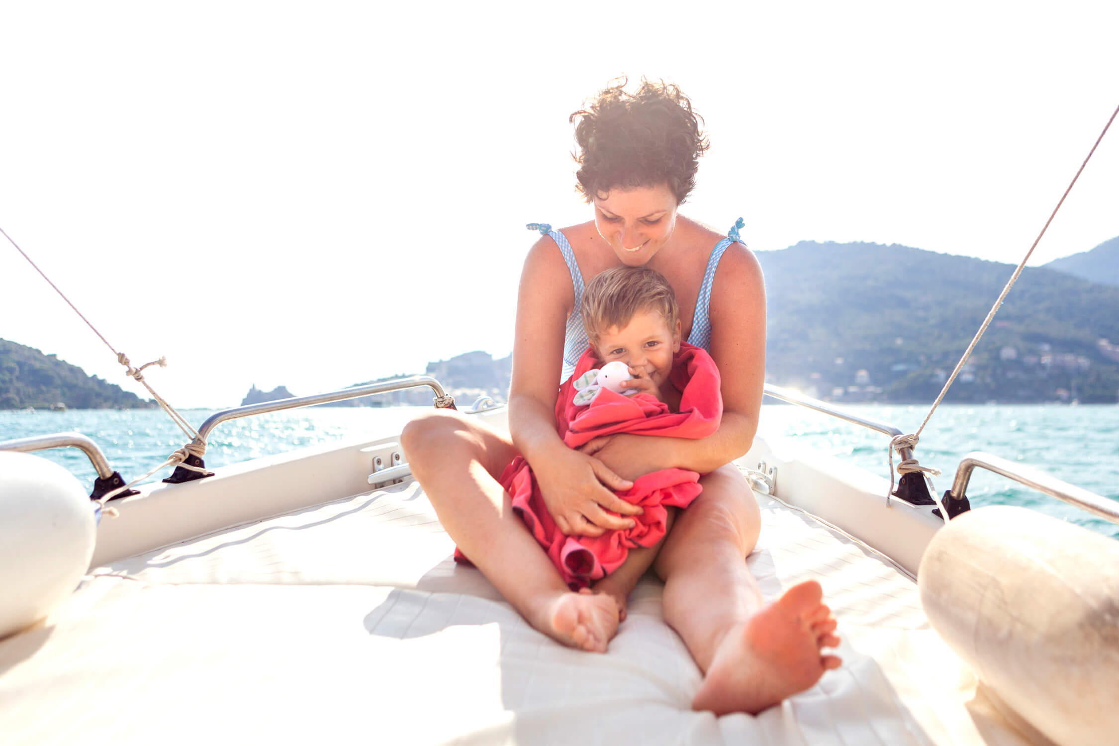 Mother with her baby on a boat in Cinque Terre during a family photo session