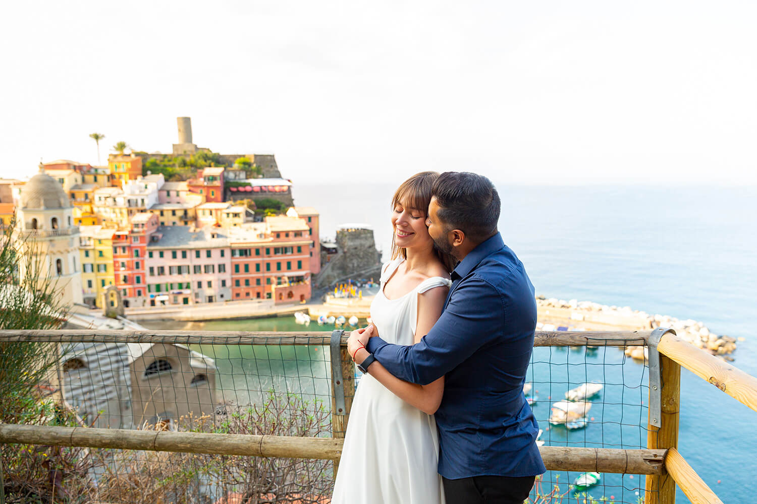 Couple hugging on a viewpoint in Vernazza, Cinque Terre, after a marriage proposal