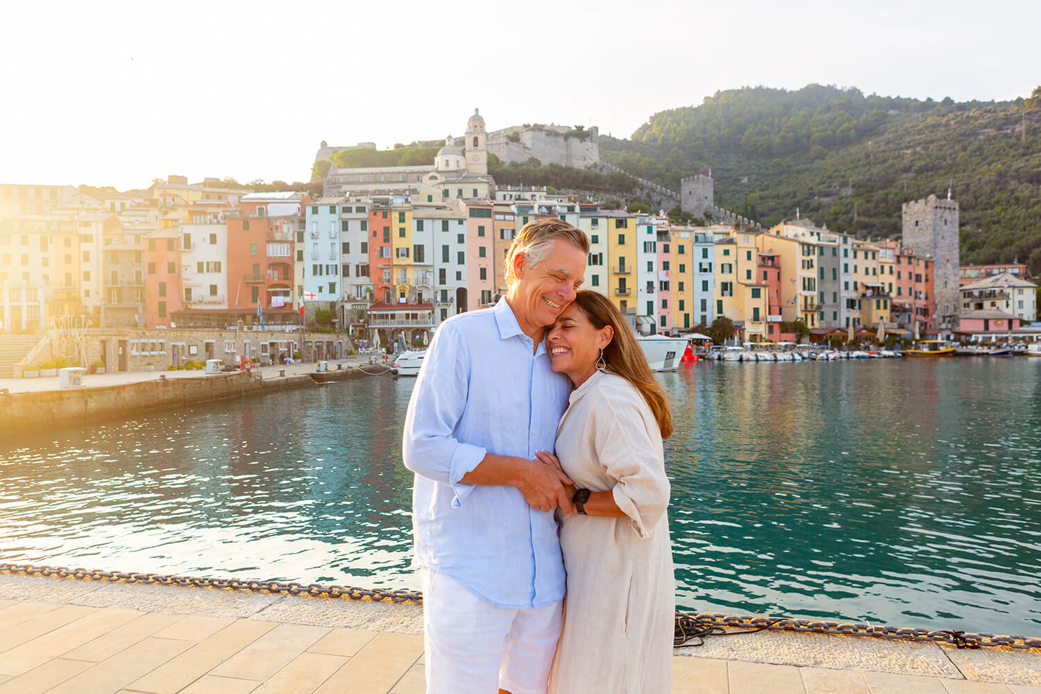 Happy couple in front of the colorful houses and sea in Portovenere, Italy