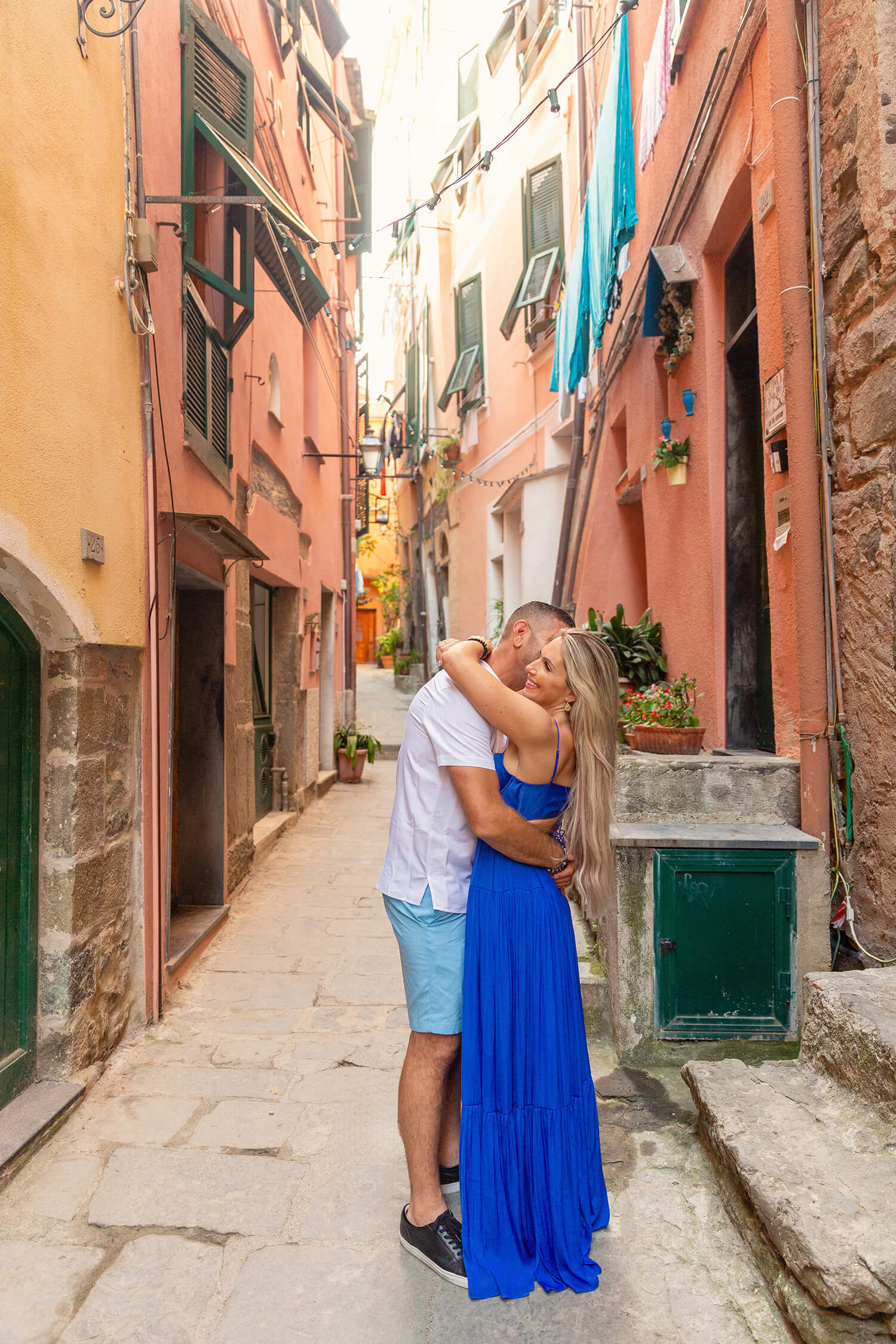 Couple hugging in a small alley in Italian Riviera