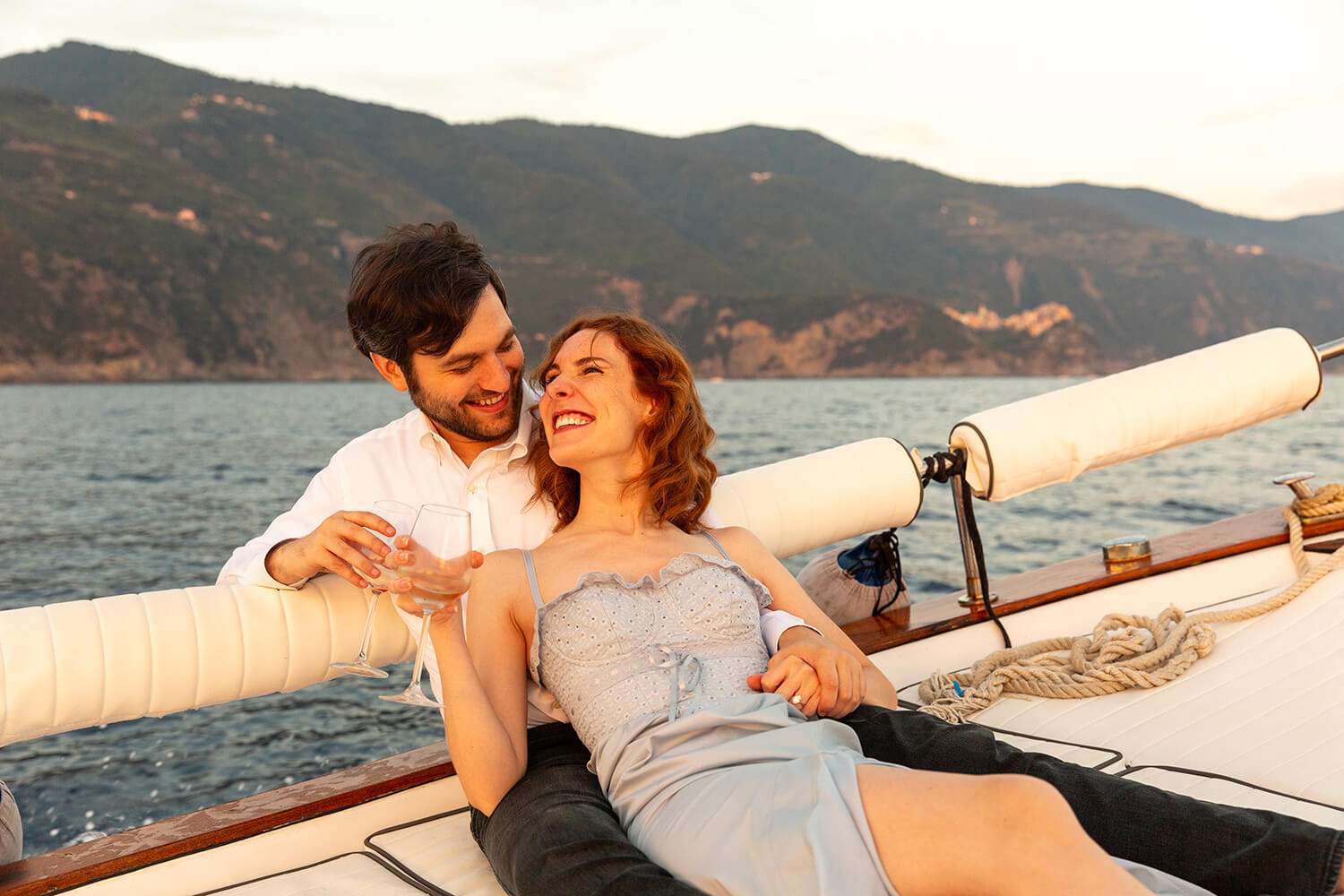Happy couple on a boat after a marriage proposal in Italy
